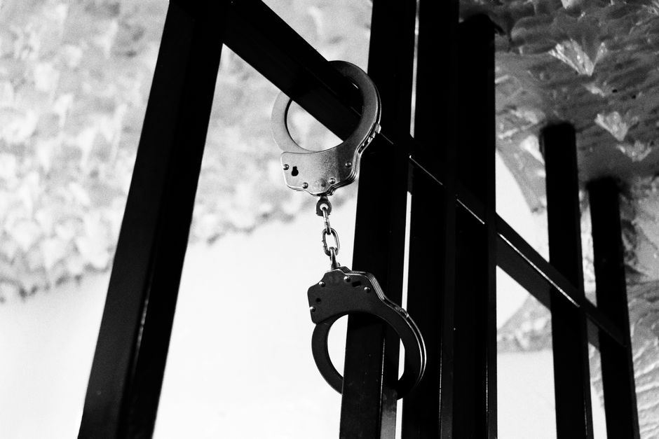 Handcuffs hanging from bars